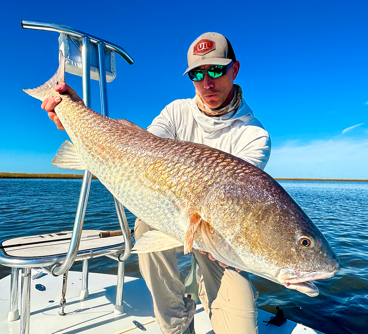 Fisherman with impressive fish on water