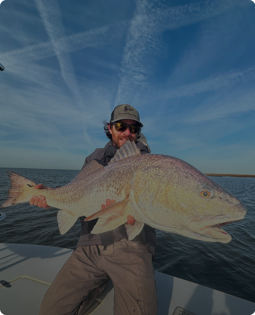 Man holding large fish on a boat
