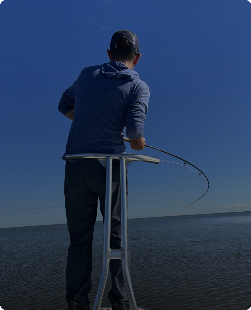 Angler on raised boat deck fishing