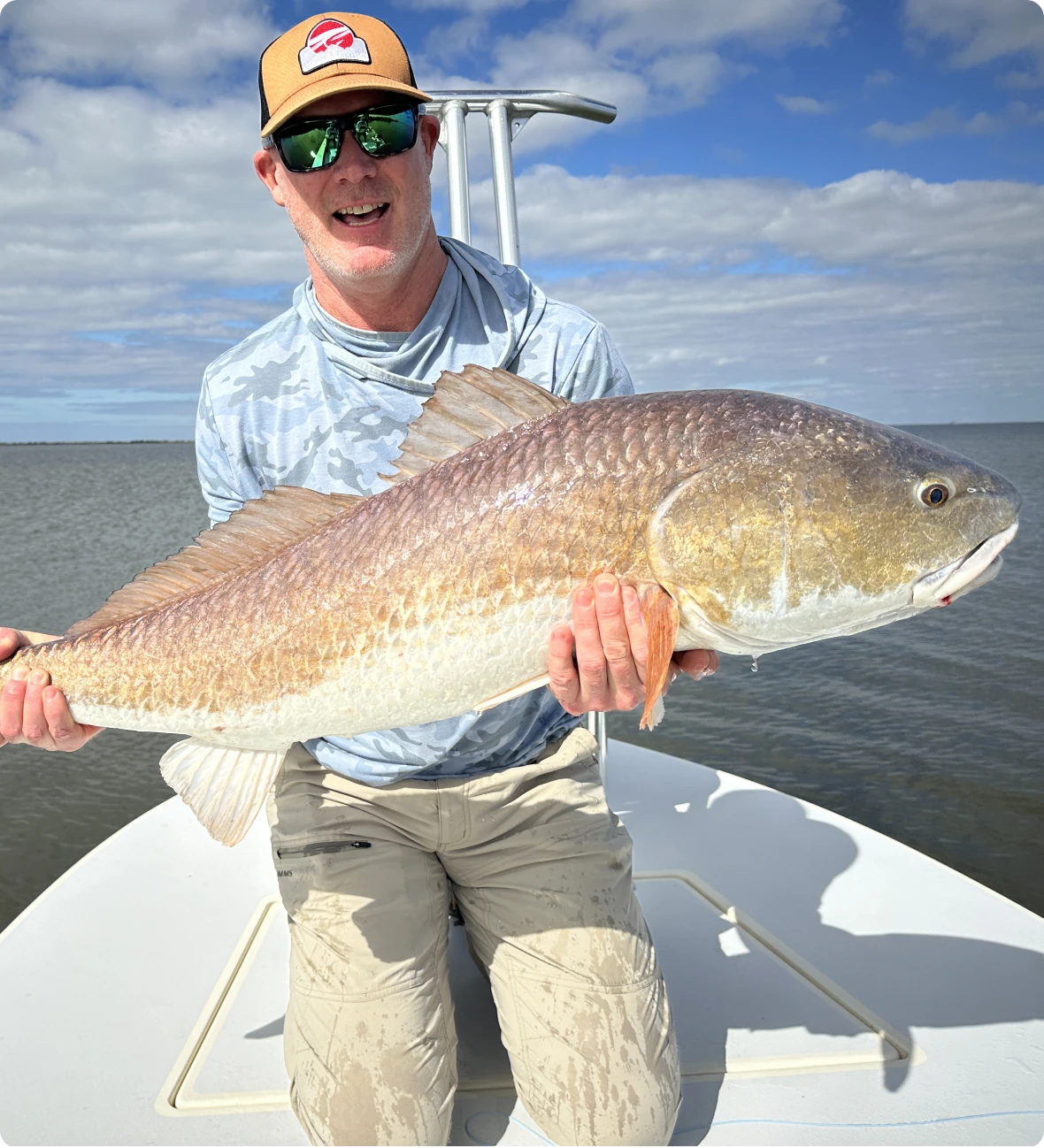 Man holding large fish on a boat