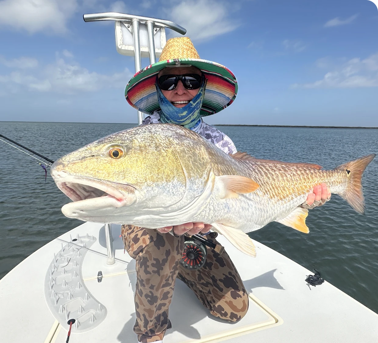Person holding large fish on boat