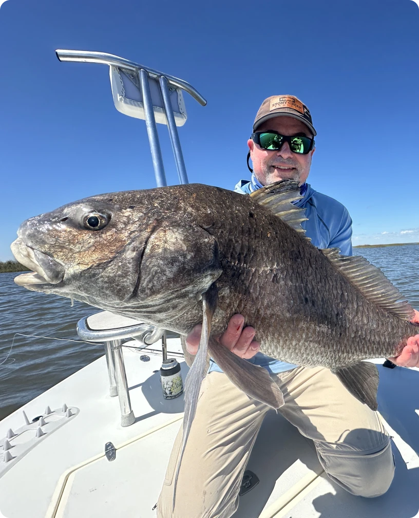 Fisherman with big catch under blue sky