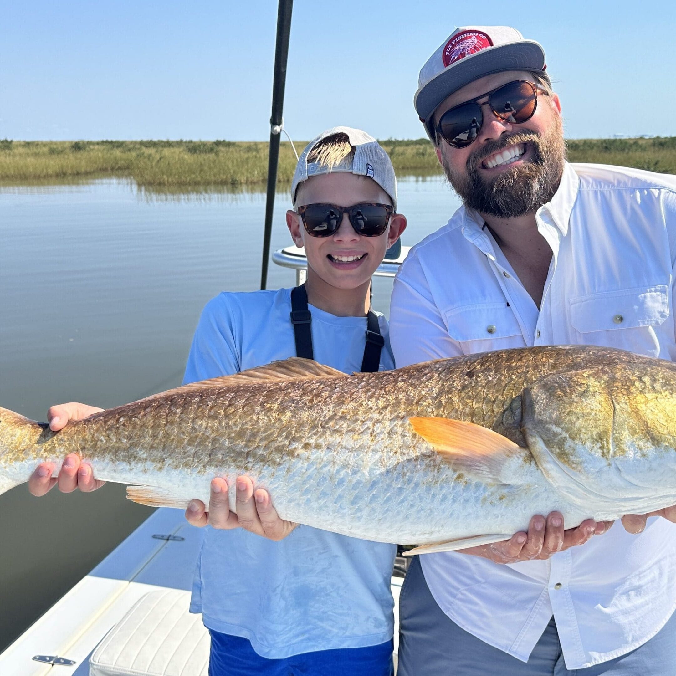 Smiling duo with impressive catch