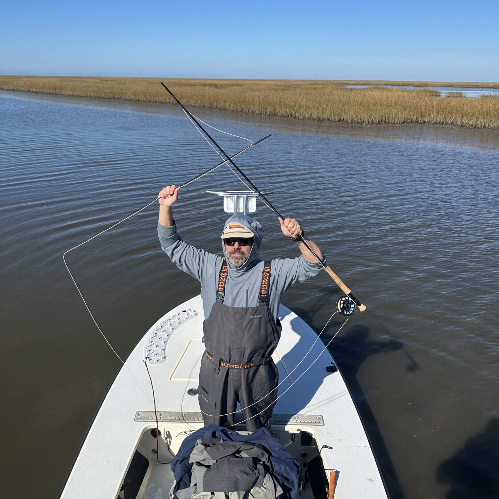 Fisherman casting on calm waters